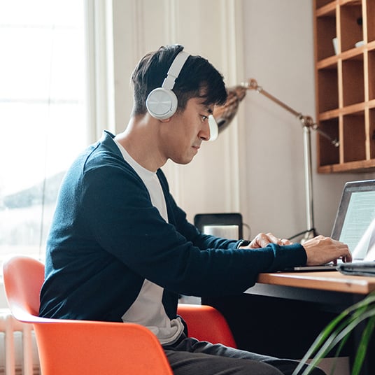 Boy sitting in front of computer